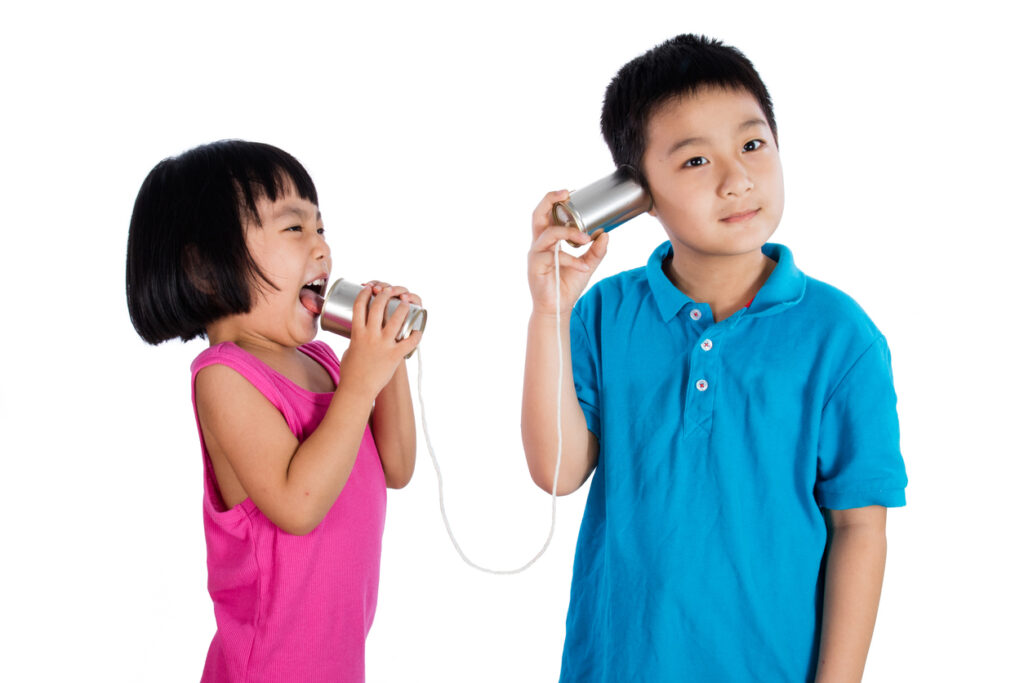 asian chinese kid playing with tin can phone