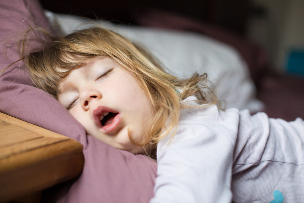 Why Good Sleep Routines Matter in Early Childhood 🛏️ funny face of child sleeping on king bed