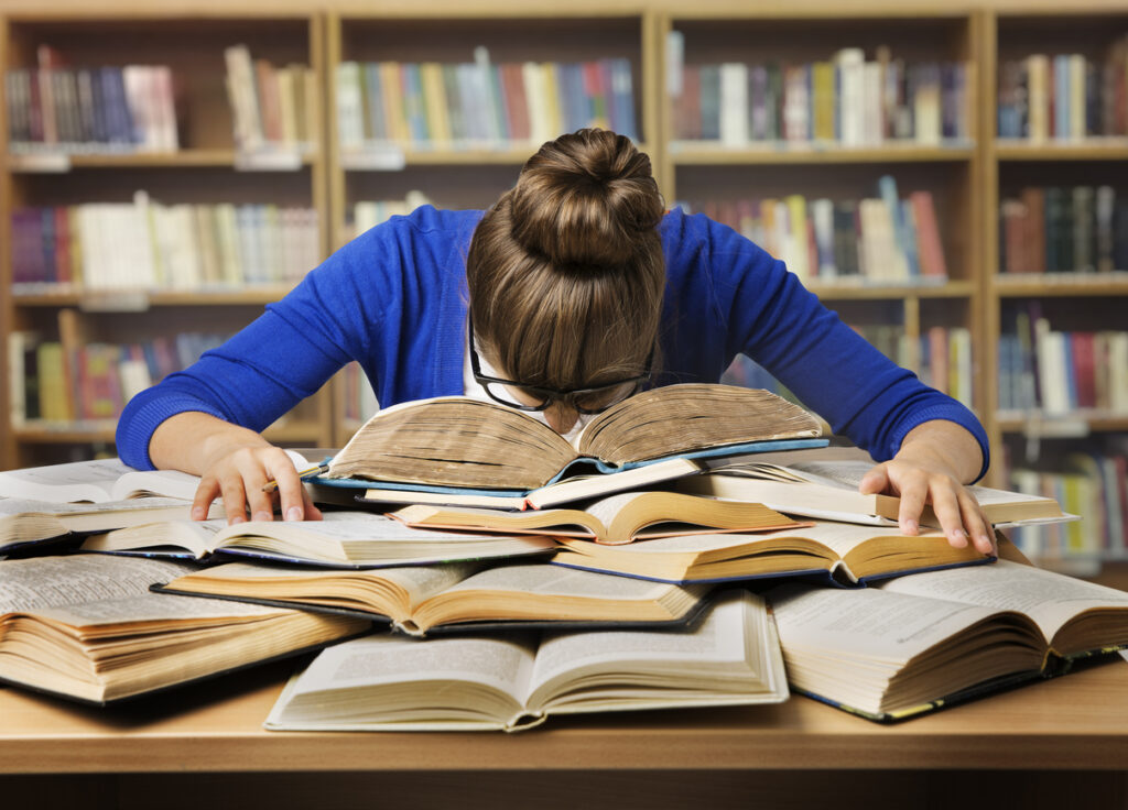 student studying sleeping on books, tired girl read book, library
