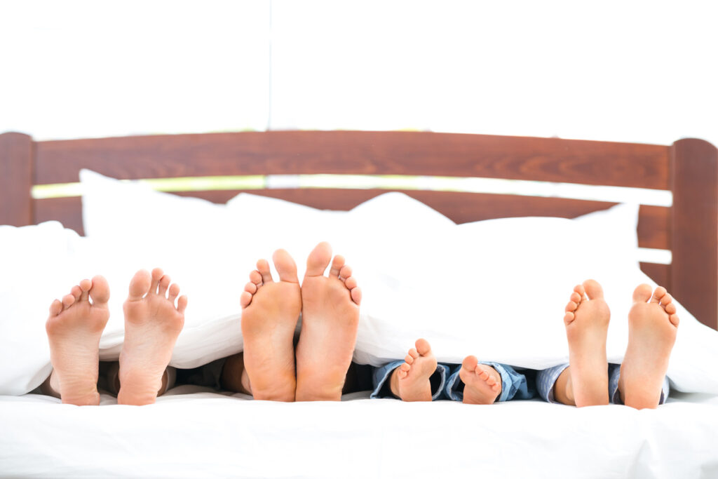 young family on white bed