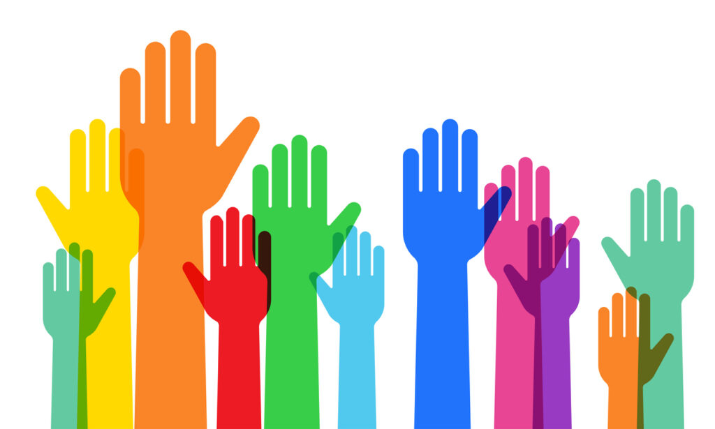 a crowd raising hands