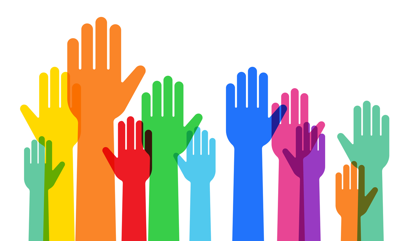 a crowd raising hands