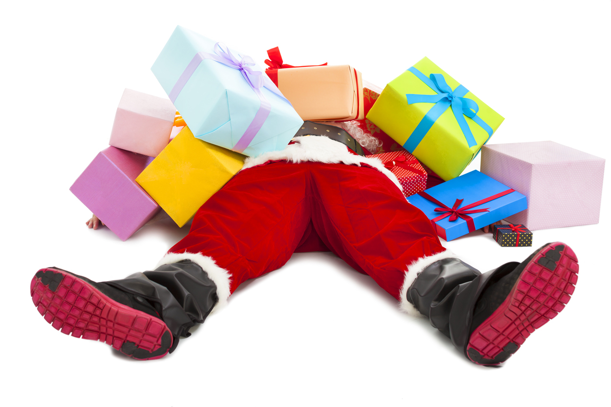 santa claus tired to lie on floor with gift boxes
